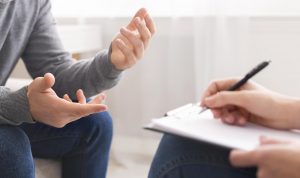 Photo of a man talking to a therapist. This photo represents how DBT therapy in Roswell, GA can help you.