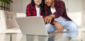 Shows two young adults looking at a laptop. Represents how anxiety counseling in alpharetta ga will support you with anxiety. Search for a "young adult therapist in roswell, ga" today!